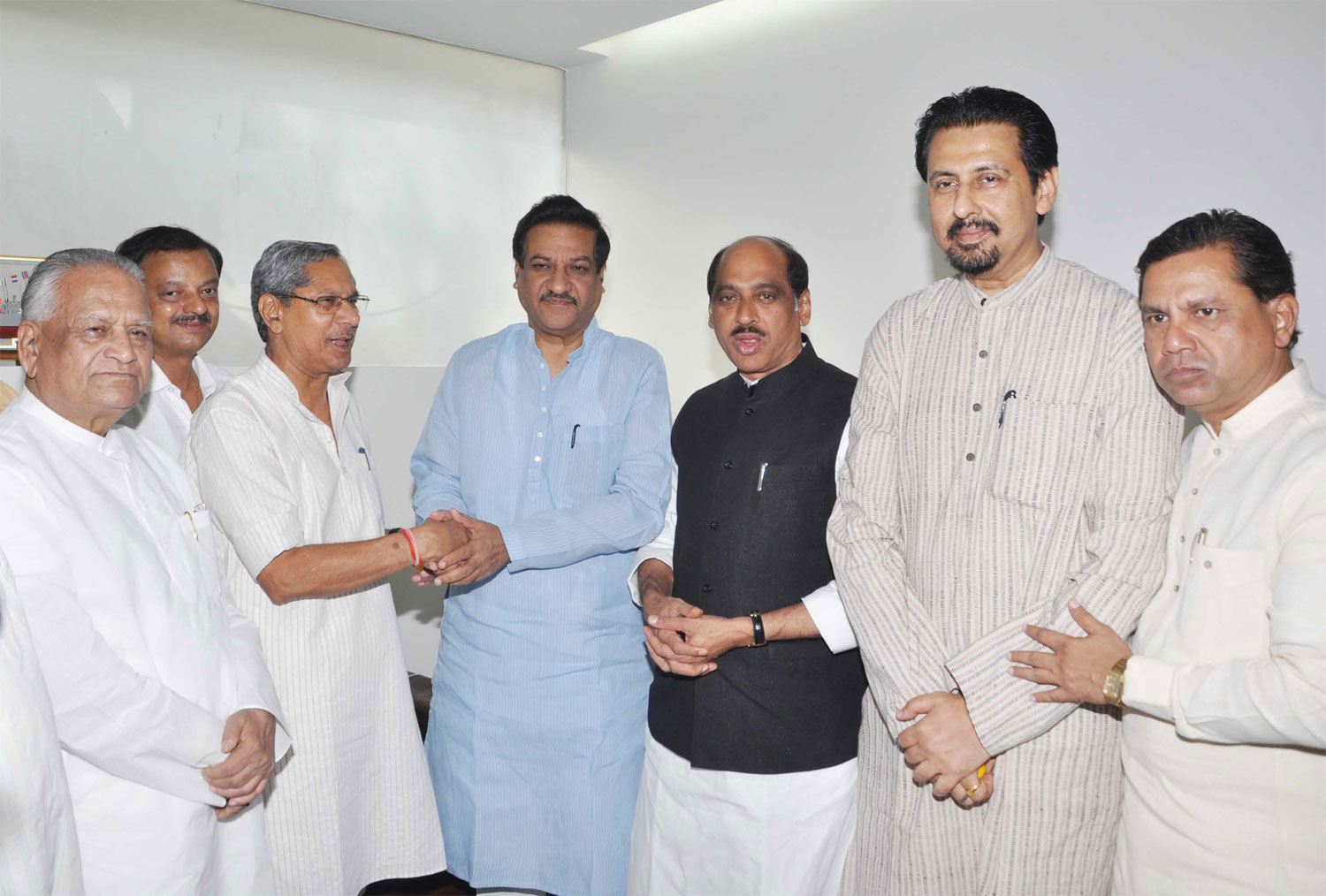AICC MAHARASHTRA OBSERVER MOHAN PRAKASHJI CONGRATULATING CHIEF MINISTER PRITHVIRAJ CHAVAN ON HIS UNANIMOUS ELECTION TO THE COUNCIL AT VARSHA BUNGALOW.