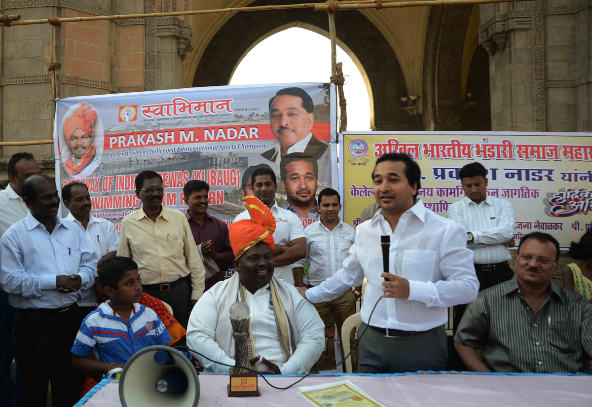 SWABHIMAAN SANGHATNA PRESIDENT NITESH NARAYANRAO RANE FELICITATED HANDICAP PRAKASH NADAR FOR HIS SWIMMING WORLD RECORD.