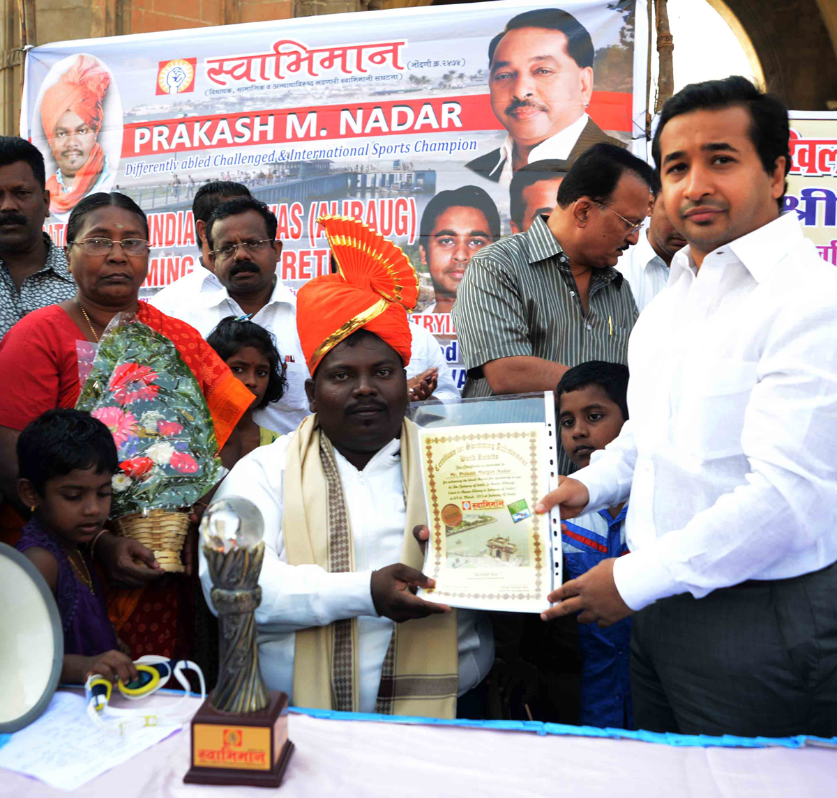 SWABHIMAAN SANGHATNA PRESIDENT NITESH NARAYANRAO RANE FELICITATED HANDICAP PRAKASH NADAR FOR HIS SWIMMING WORLD RECORD.